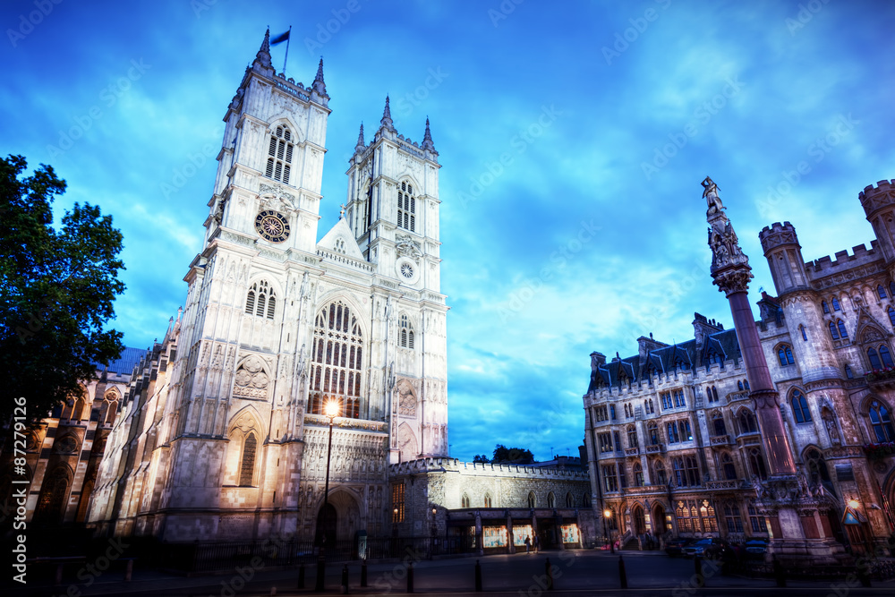 Westminster Abbey church facade at night, London UK.