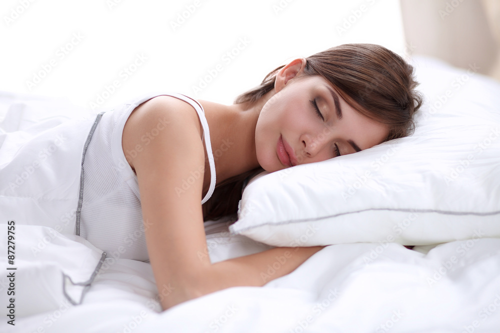 Beautiful girl sleeps in the bedroom, lying on bed Beautiful girl sleeps in the bedroom, lying on bed