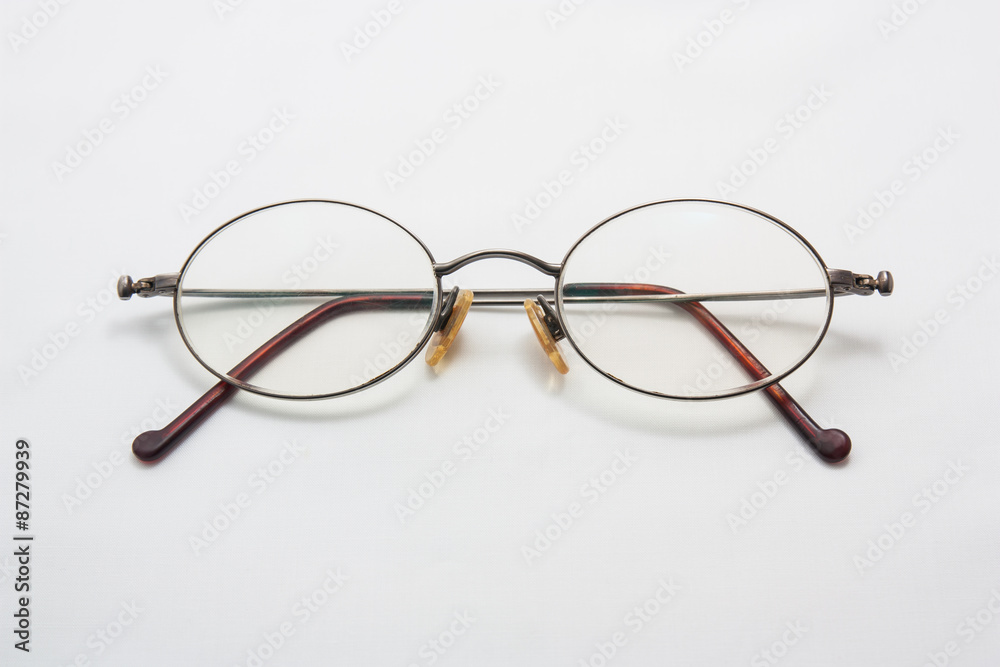 Fototapeta premium Old eye glasses on a white background.