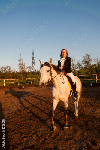 Horsewoman at hippodrome and blue sky