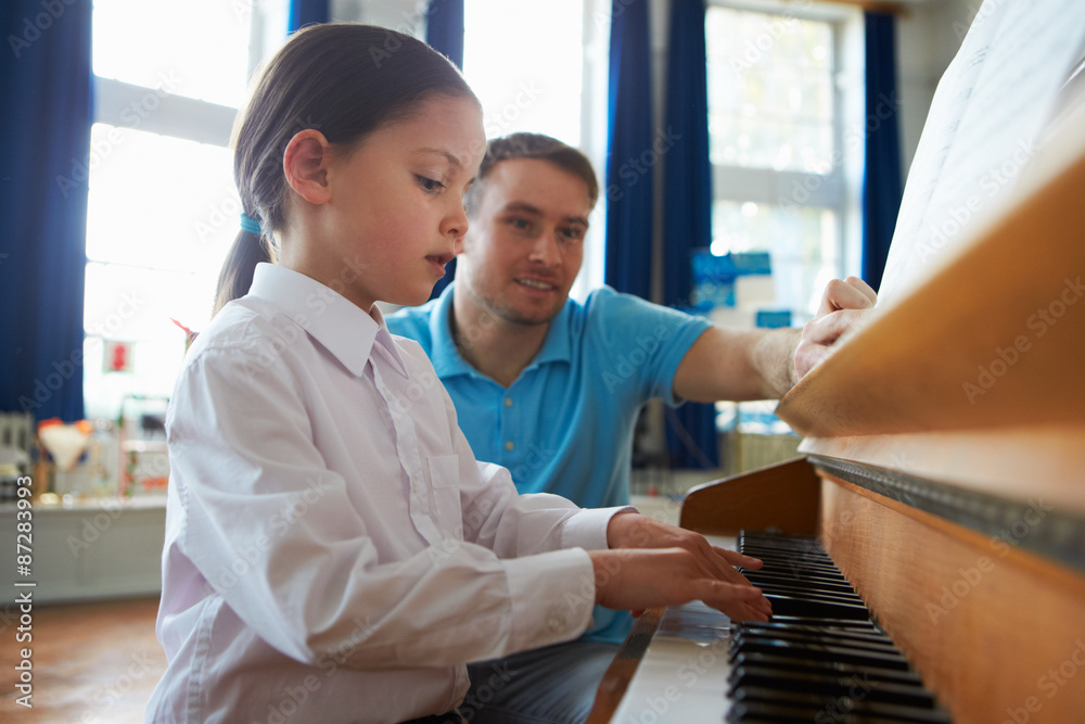 Female Student Enjoying Piano Lesson With Teacher Stock Photo | Adobe Stock