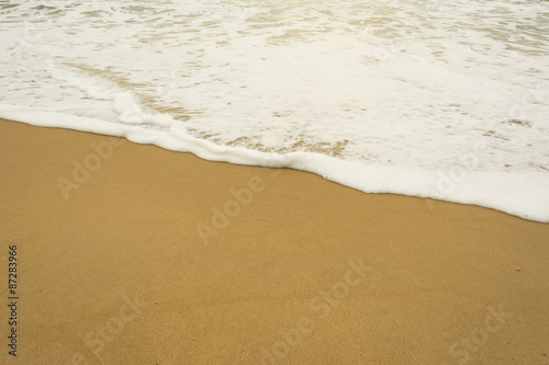 Sea wave and many foot print on the beach background