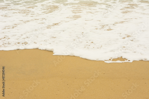 Sea wave and many foot print on the beach background