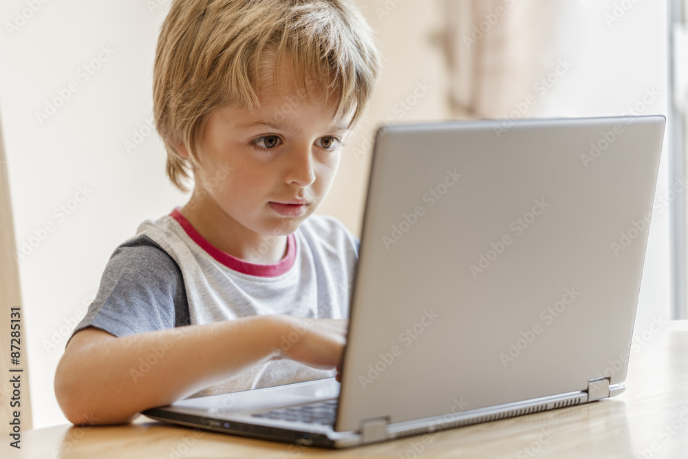 Boy working on laptop computer Boy working on laptop computer