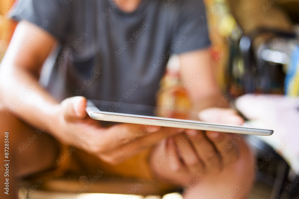 young man with a tablet computer in a rustic place