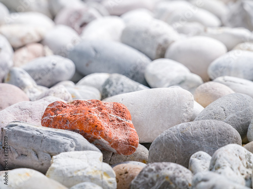 Canvas Print Orange stone among other stones