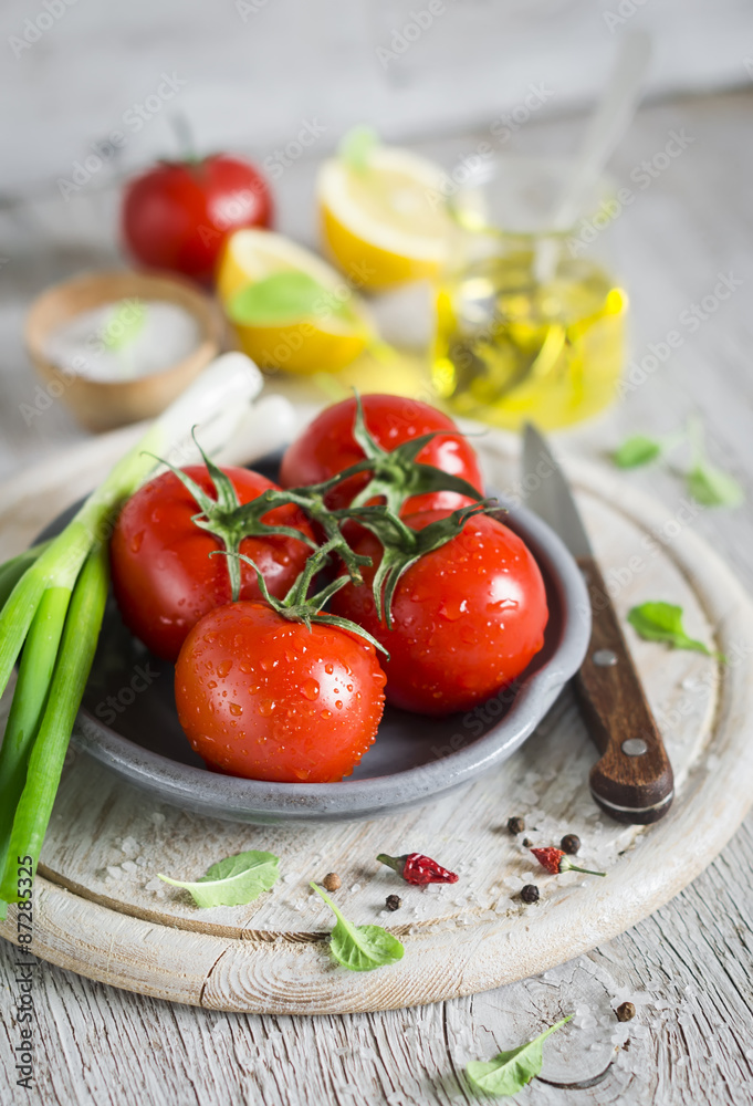 fresh tomatoes on a light wooden background fresh tomatoes on a light wooden background