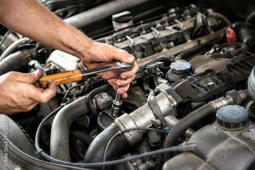 Mechanic using a wrench and socket photo