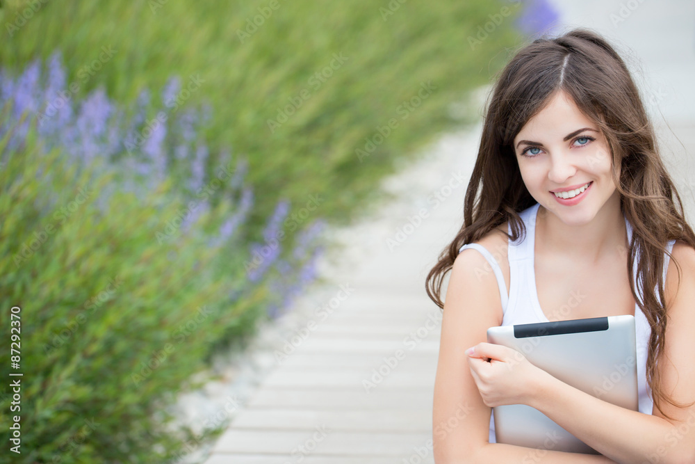 Modern girl student holding an electronic tablet Modern girl student holding an electronic tablet