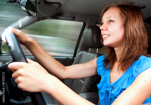 Young adult girl driving a car first time
