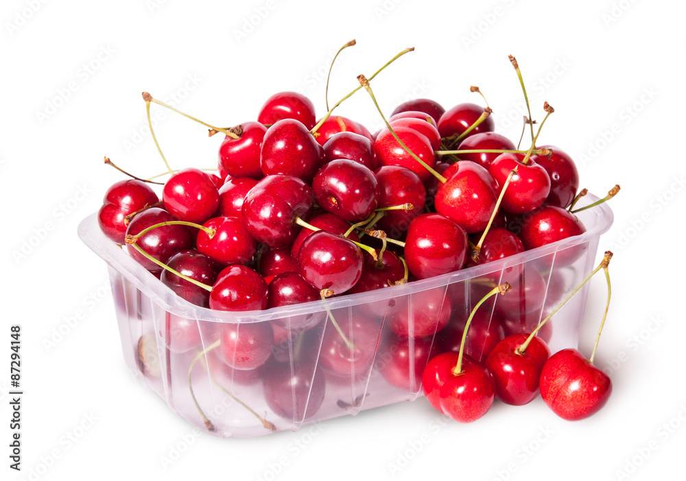 Sweet cherries in plastic tray and three near top view Sweet cherries in plastic tray and three near top view