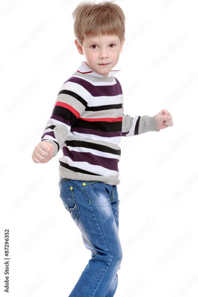 Cheerful little boy in a striped sweater and blue jeans Cheerful little boy in a striped sweater and blue jeans