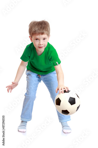 Funny cute little boy in a green t-shirt and jeans