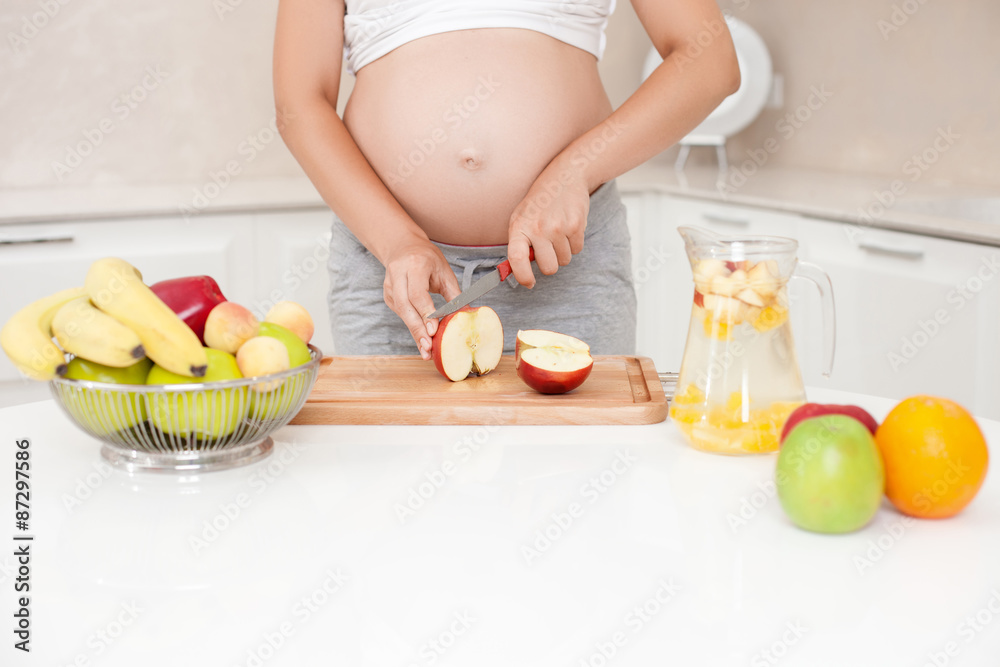 Young healthy pregnant woman is doing lemonade