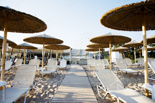 Parasol and sunbeds at sunset