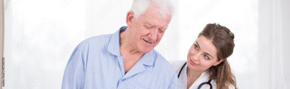 Weakened man supported by nurse Weakened man supported by nurse