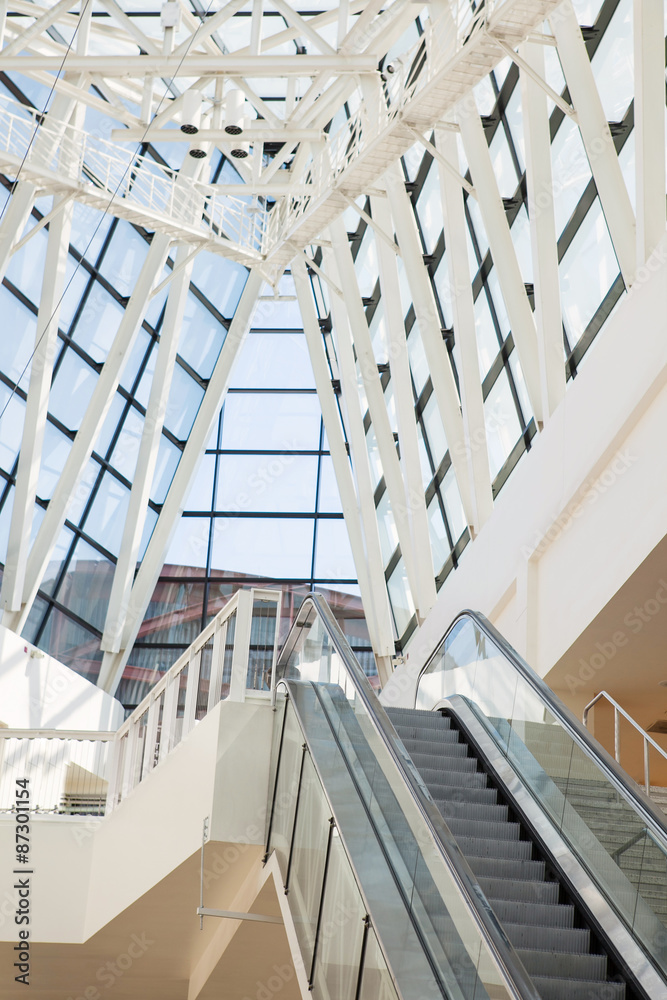 Obraz premium escalator and glass roof in futuristic hi-tech building.