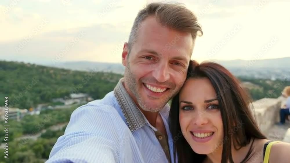 Beautiful Greek couple takes a selfie with Greece in the background. Beautiful Greek couple takes a selfie with Greece in the background.