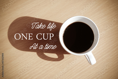 Quote with coffee cup on wood background
