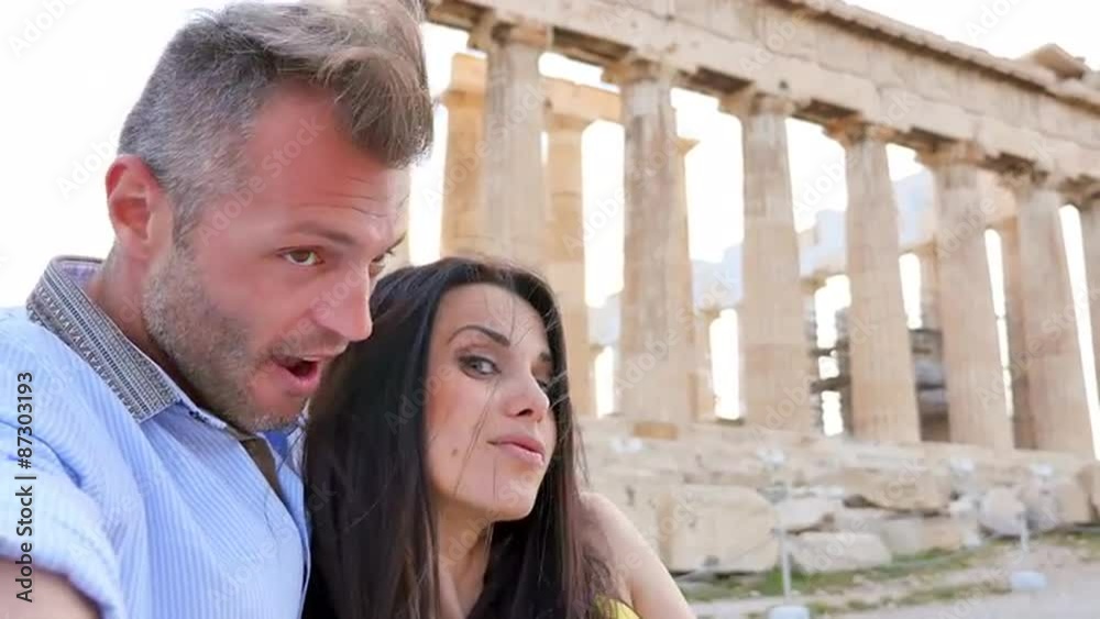 Beautiful Greek couple takes a selfie with historical Greek architecture in the background. Beautiful Greek couple takes a selfie with historical Greek architecture in the background.