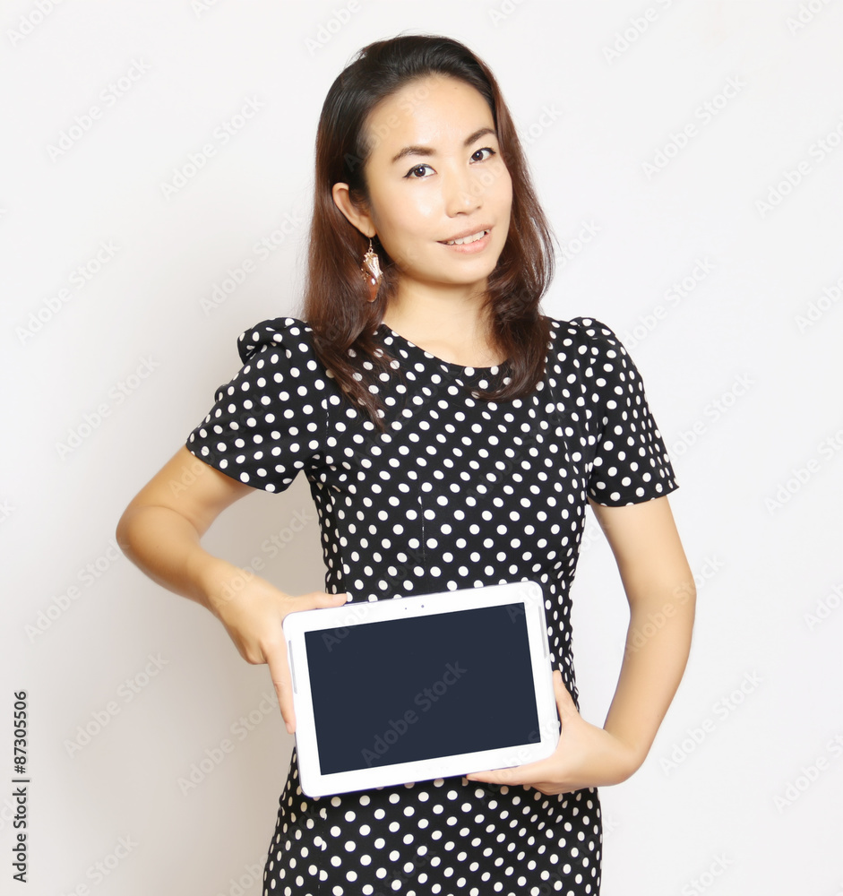 Naklejka premium Asian woman using a tablet to work on a white background.