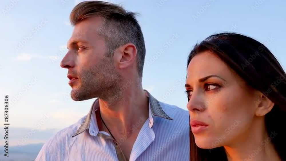 Greek Couple look out over Greece at a viewpoint at sunset. Greek Couple look out over Greece at a viewpoint at sunset.