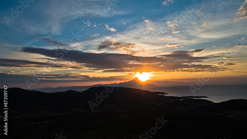 Greek coast of aegean sea at sunrise near holy mountain Athos