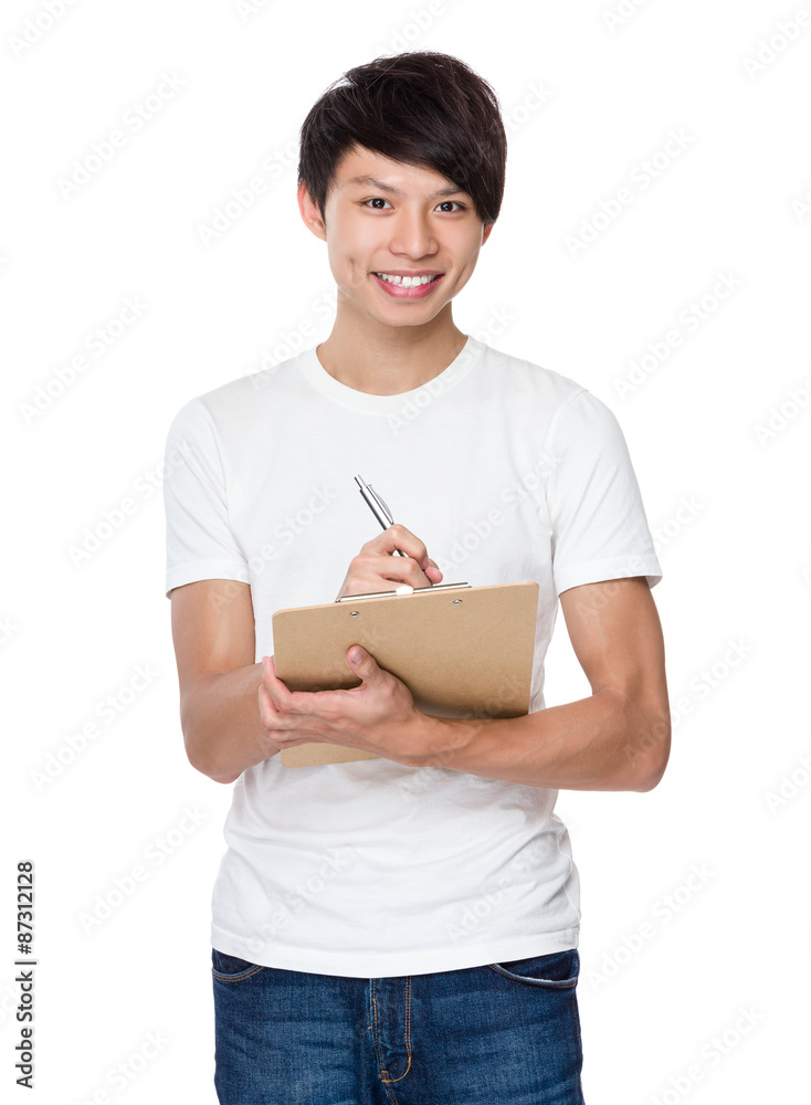 Asian man take note on clipboard Asian man take note on clipboard