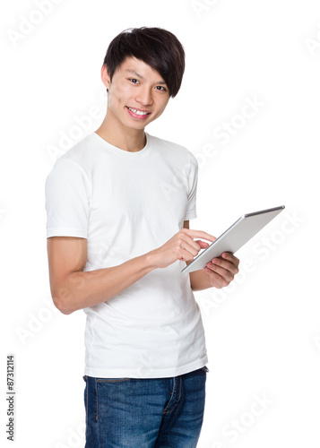 Asian young man use of the tablet pc