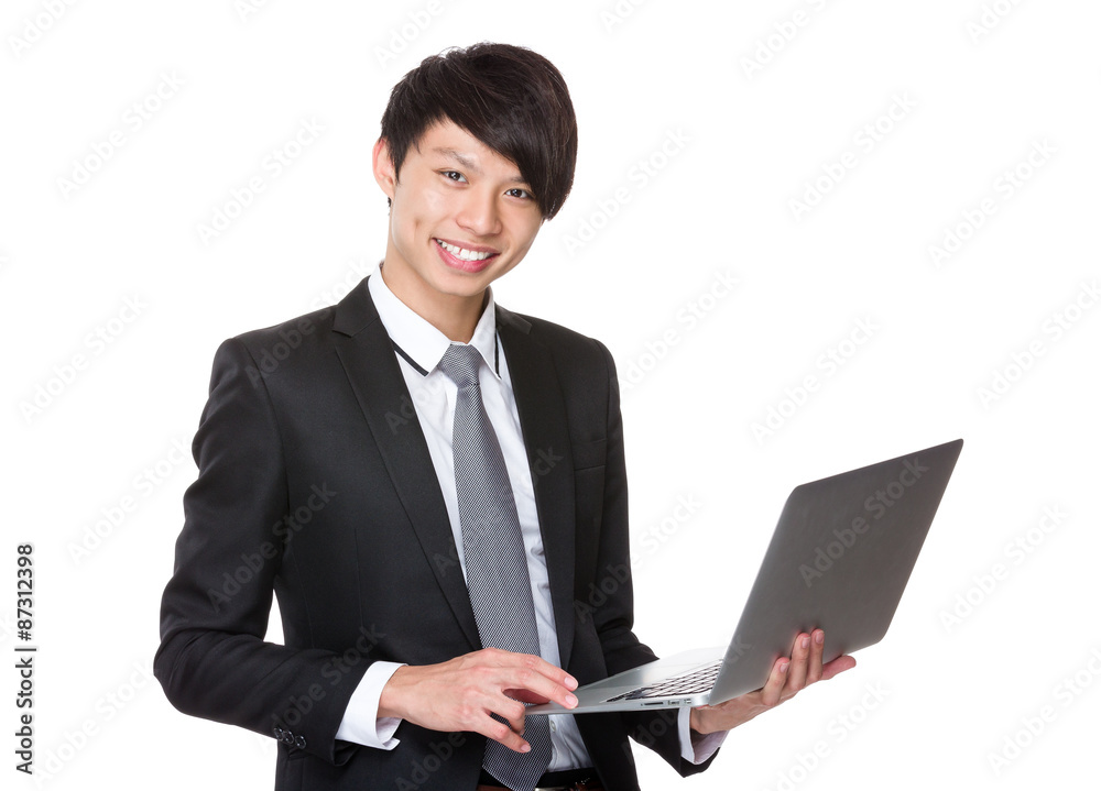 Asian Young businessman use of the notebook computer Asian Young businessman use of the notebook computer