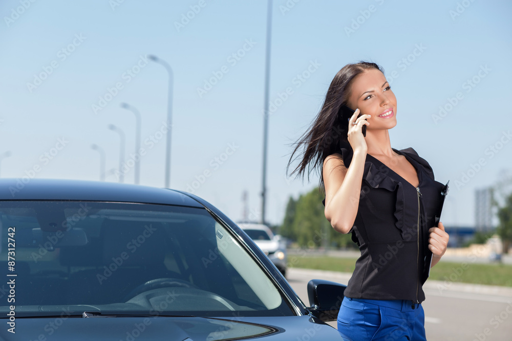 Beautiful young businesswoman is talking on the telephone Beautiful young businesswoman is talking on the telephone
