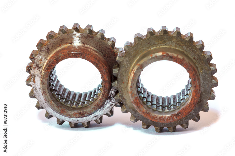 Heavy metal gears linked together on white background. Heavy metal gears linked together on white background.