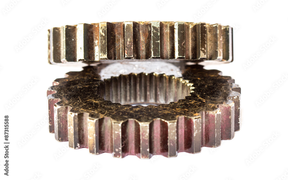 A dirty industrial gear isolated on a white background A dirty industrial gear isolated on a white background
