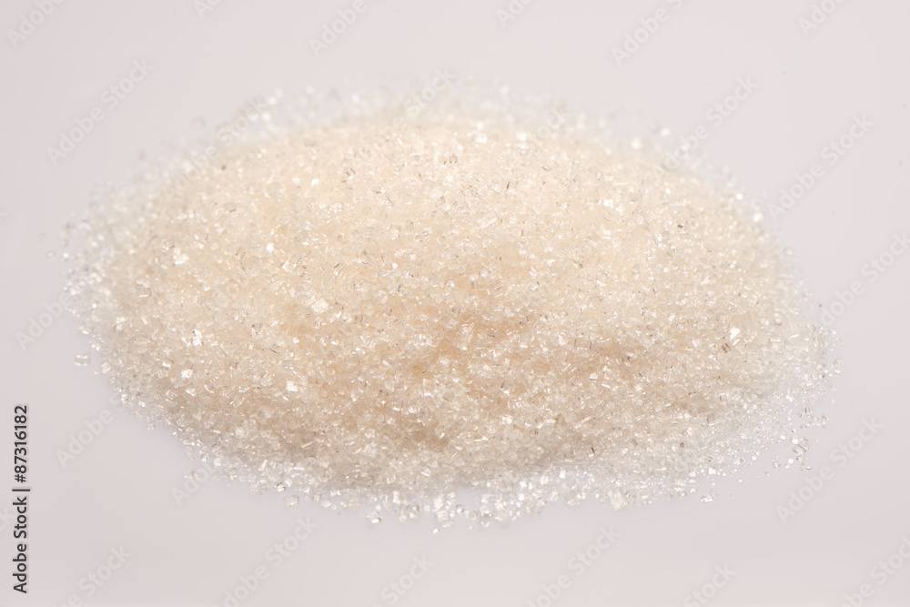 Pile of sugar on white background