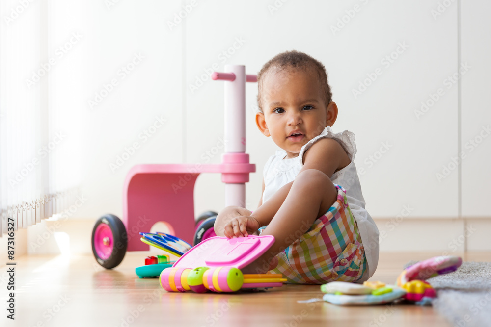 Portrait of little African American little girl sitting on the f Portrait of little African American little girl sitting on the f