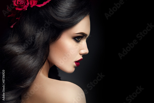 Beauty Fashion Model Girl Portrait with Roses Hairstyle. Red