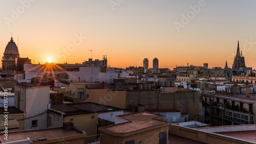 Photography sunrise over the houses of barcelona with view on the cathedral