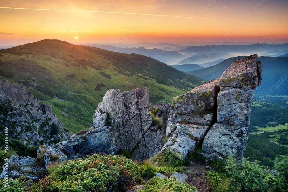 High rocks in mountain valley during sunrise. Natural summer landscape