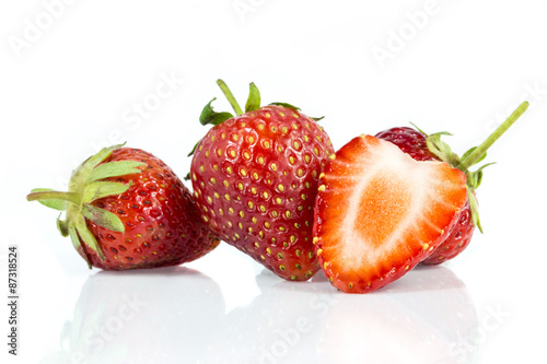 Stawberries and cutted isolated on white background