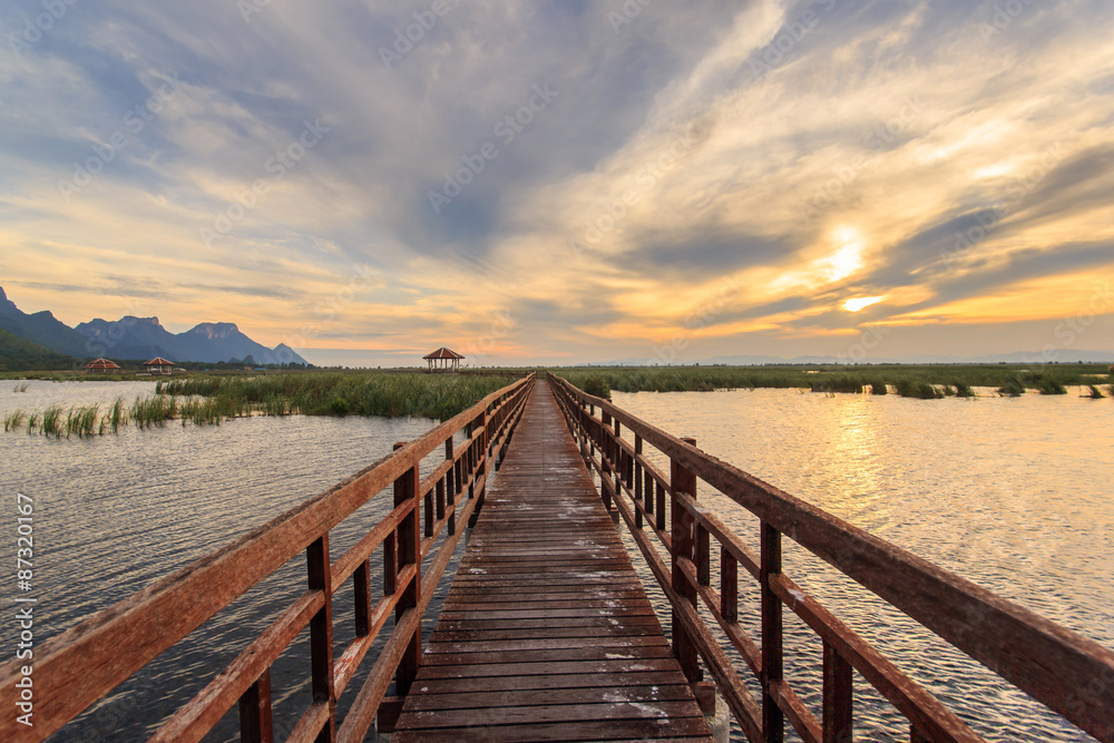Wooden Bridge in lotus lake on sunset time at Khao Sam Roi Yot National Park, Thailand