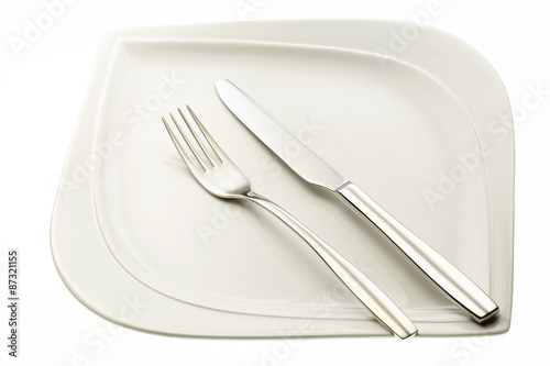 Stainless fork and knife on plate