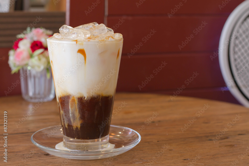Ice Coffee with milk on the wood desk Ice Coffee with milk on the wood desk