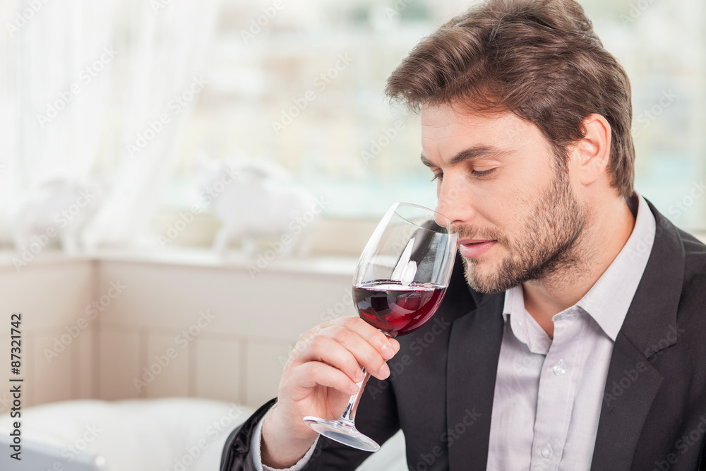 Young well-dressed man is relaxing in restaurant Young well-dressed man is relaxing in restaurant