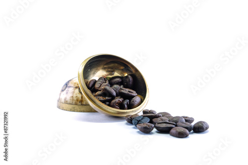 Coffee beans with brass bolw isolated on white background