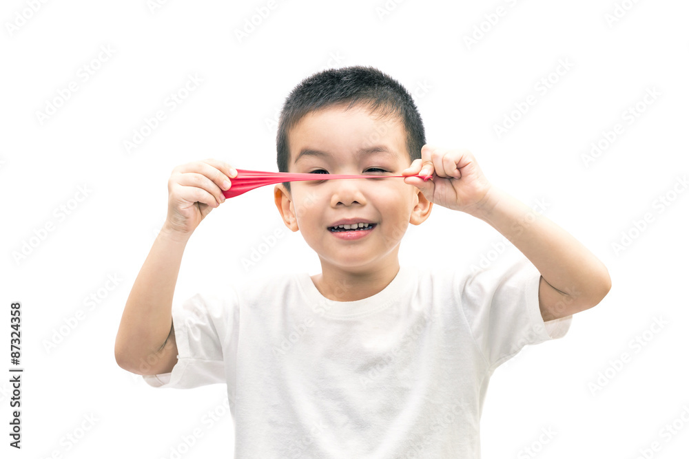 Little asian boy stretch a red balloon isolated on white backgro Little asian boy stretch a red balloon isolated on white backgro