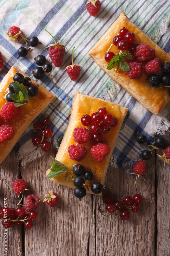 cakes with berries, honey and mint close-up. vertical top view
