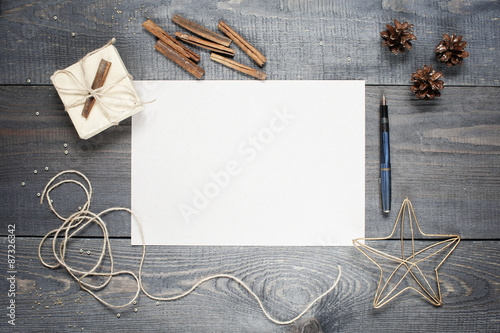 Blank sheet of paper with composition on the dark wooden texture