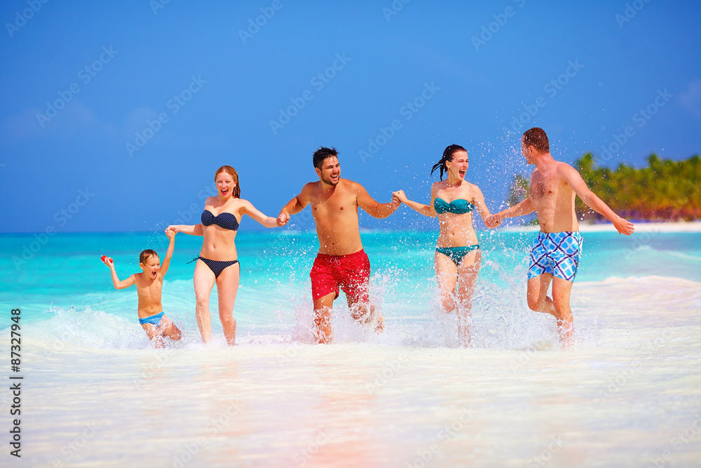 group of happy friends having fun together on tropical beach group of happy friends having fun together on tropical beach