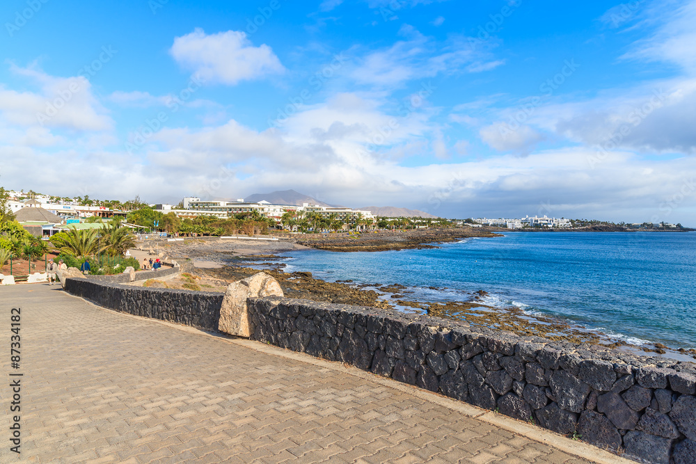 Promenade along ocean coast in Playa Blanca holiday resort, Lanzarote, Canary Islands, Spain