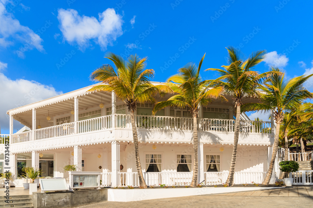 Caribbean style building and palm trees in Puerto Calero marina, Lanzarote, Canary Islands, Spain Caribbean style building and palm trees in Puerto Calero marina, Lanzarote, Canary Islands, Spain